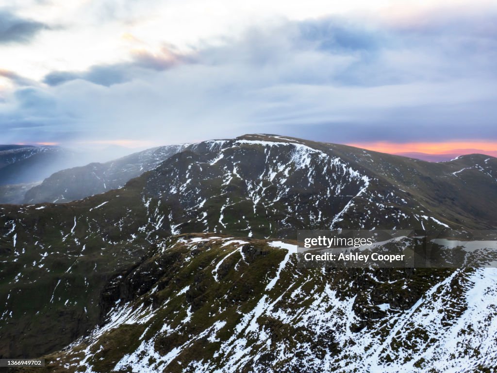 Fairfield in the Lake District at dawn, from the summit of Dollywagon Pike, UK at dawn with a passing snow sahower.