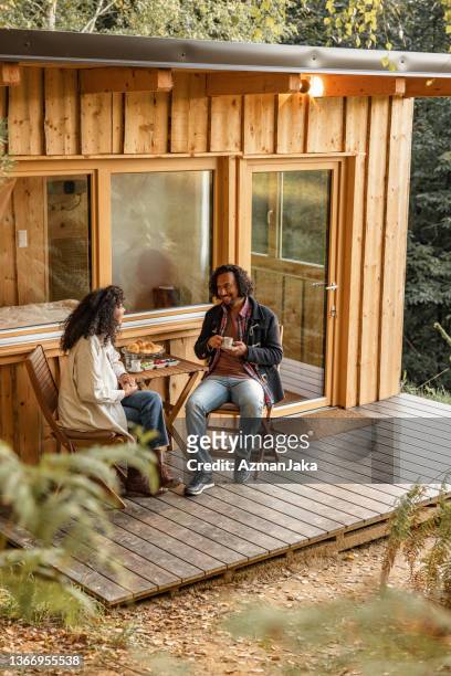 hispanic couple having breakfast outdoors - ideal wife stock pictures, royalty-free photos & images