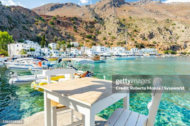 bar on sea front in summer, loutro, greece - cafe front photos et images de collection