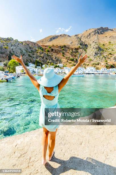 cheerful woman with sun hat enjoying summer - arm sun beach stock-fotos und bilder