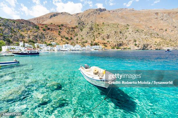 boats moored in the transparent sea, crete - creta fotografías e imágenes de stock