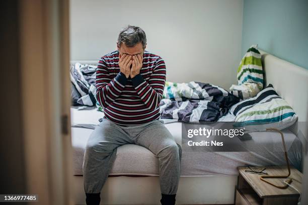 a homeless man in a homeless shelter - homeless shelter stock pictures, royalty-free photos & images