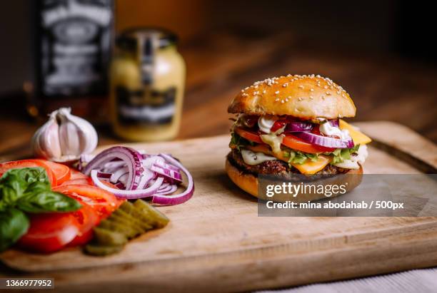 close-up of burger on cutting board,germany - burger grill stock-fotos und bilder