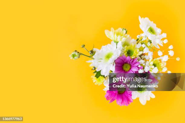 bouquet of flowers on a yellow background. spring flower composition. - ramo de flores fotografías e imágenes de stock