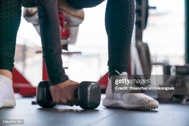 shot of young woman exercise workout in gym fitness with dumbbel. - kardiovaskulär träning bildbanksfoton och bilder