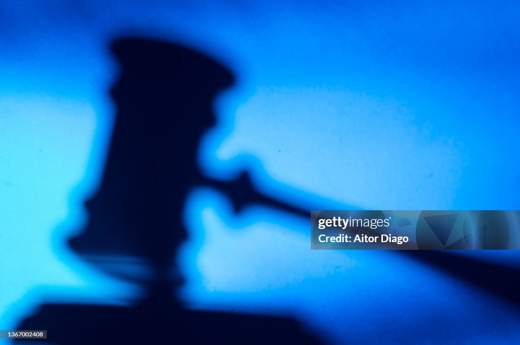 Silhouette of a judge's gavel. Cryptocurrencies and legality