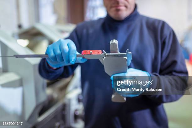 engineer measuring titanium blanks in industrial forge - titanium stock pictures, royalty-free photos & images