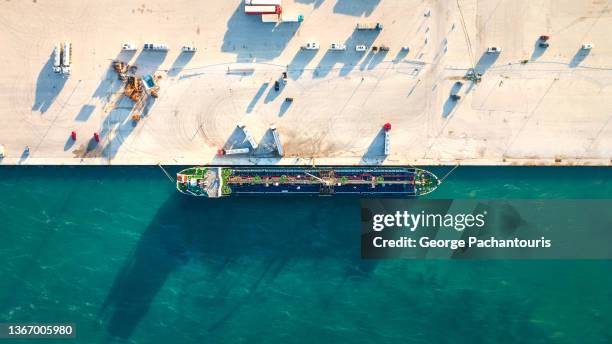 top down aerial photo of a tanker ship on the harbor - greece aerial stock pictures, royalty-free photos & images