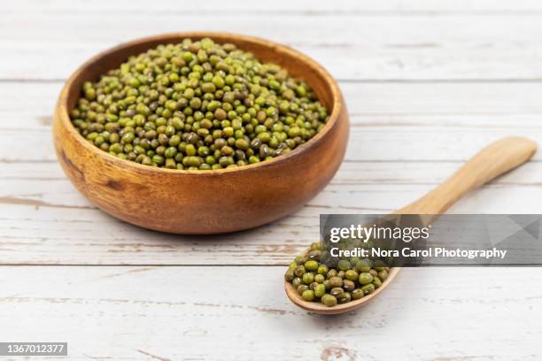 mung bean on a wooden bowl - mung bean stock pictures, royalty-free photos & images