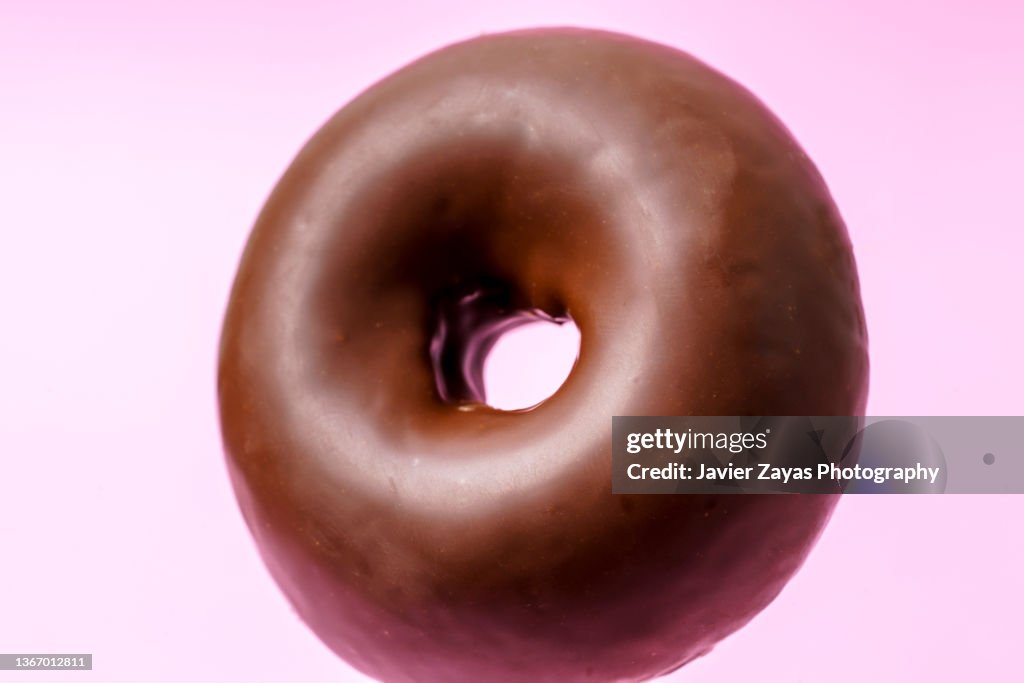 Chocolate Doughnut On Pink Colored Background