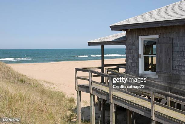 beach house with surf and ocean horizon - beach cottage stock pictures, royalty-free photos & images