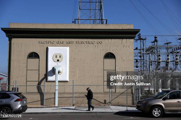 Pedestrian walks by a Pacific Gas & Electric electrical substation on January 26, 2022 in Petaluma, California. The Department of Homeland Security...