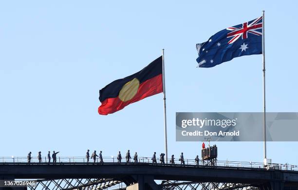 The Aboriginal flag flies alongside the Australian flag on January 26, 2022 in Sydney, Australia. Australia Day, formerly known as Foundation Day, is...