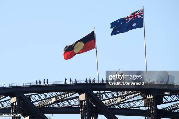 The Aboriginal flag flies alongside the Australian flag on January 26, 2022 in Sydney, Australia. Australia Day, formerly known as Foundation Day, is...