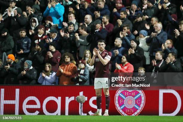 John Souttar of Heart of Midlothian and fans participates in a minute applause during the 13th minute in honour of Devin Gordon during the Cinch...