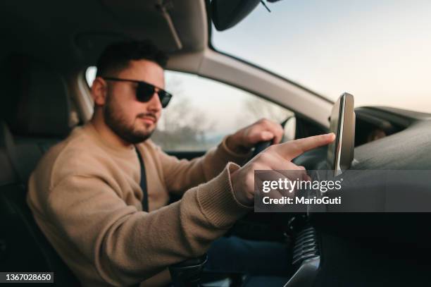 touching a touch screen of a car - car screen dashboard stock pictures, royalty-free photos & images