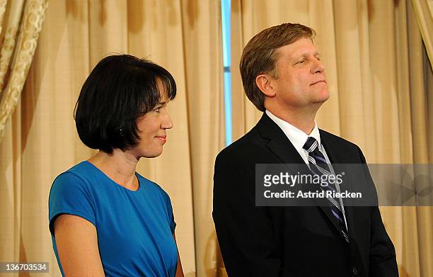 Ambassador-Designate to Russia Michael McFaul and his wife Donna Norton listen to remarks by U.S. Secretary of State Hillary Clinton at his...