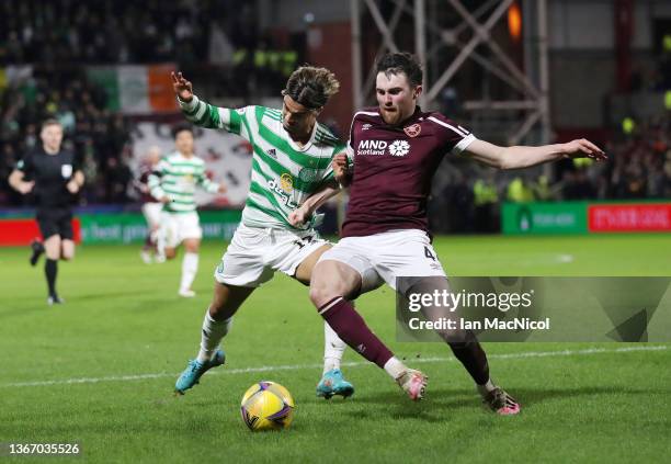 John Souttar of Heart of Midlothian battles for possession with Jota of Celtic during the Cinch Scottish Premiership match between Heart of...