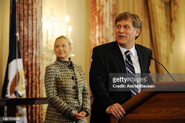 Secretary of State Hillary Clinton smiles at a remark made by Ambassador-Designate to Russia Michael McFaul during his swearing-in ceremony at the...