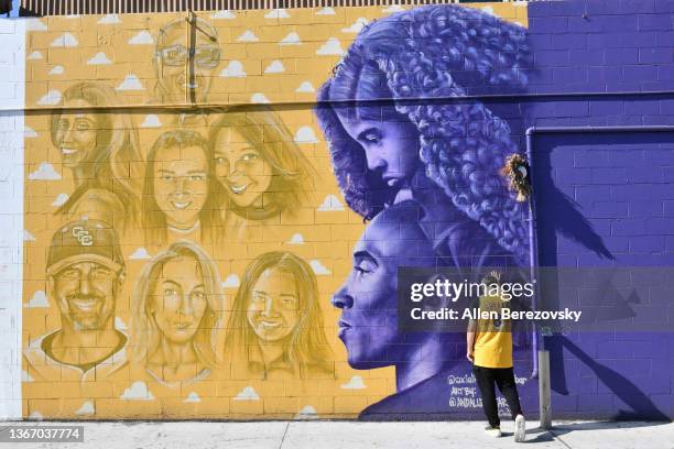 Costa Mesa, CALIFORNIA A fan pays tribute at a mural by Andaluz the Artist of Kobe Bryant, Gianna Bryant, Alyson Altobelli, John Altobelli, Keri...