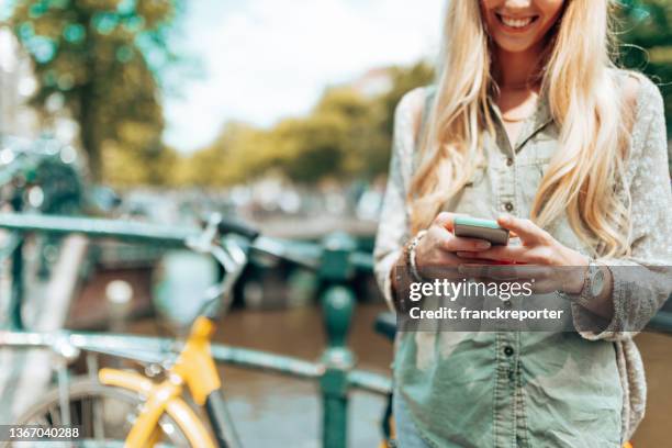 woman on the phone in amsterdam - sea channel stock pictures, royalty-free photos & images