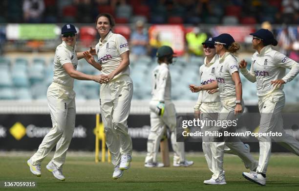 Heather Knight and Natalie Sciver of England celebrate the dismissal of Ellyse Perry of Australia during day one of the Women's Test match in the...