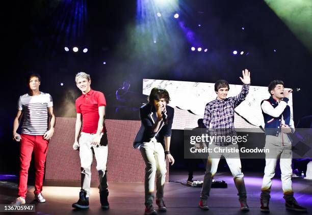 Louis Tomlinson, Niall Horan, Harry Styles, Liam Payne and Zayn Malik of One Direction perform on stage at HMV Hammersmith Apollo on January 10, 2012...