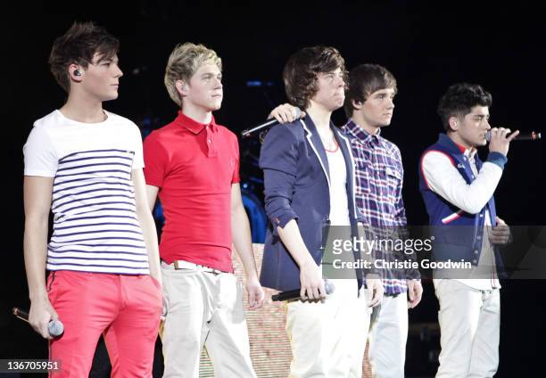 Louis Tomlinson, Niall Horan, Harry Styles, Liam Payne and Zayn Malik of One Direction perform on stage at HMV Hammersmith Apollo on January 10, 2012...