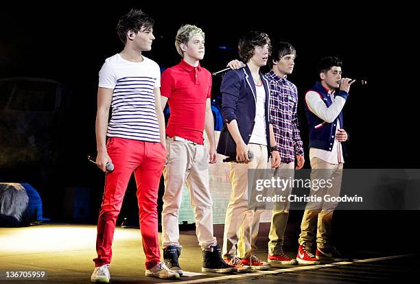 Louis Tomlinson, Niall Horan, Harry Styles, Liam Payne and Zayn Malik of One Direction perform on stage at HMV Hammersmith Apollo on January 10, 2012...