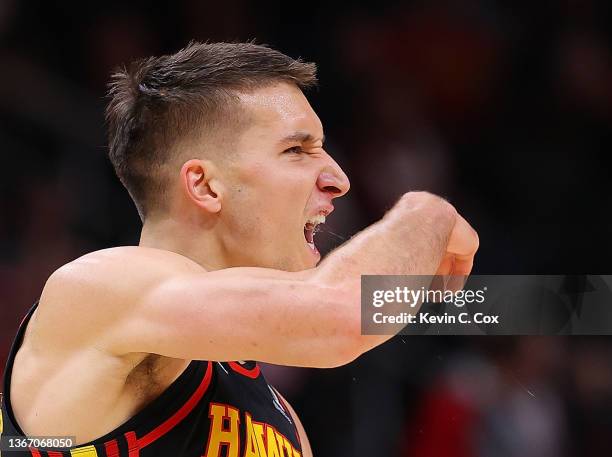 Bogdan Bogdanovic of the Atlanta Hawks reacts after a three-point basket against the Sacramento Kings during the first half at State Farm Arena on...