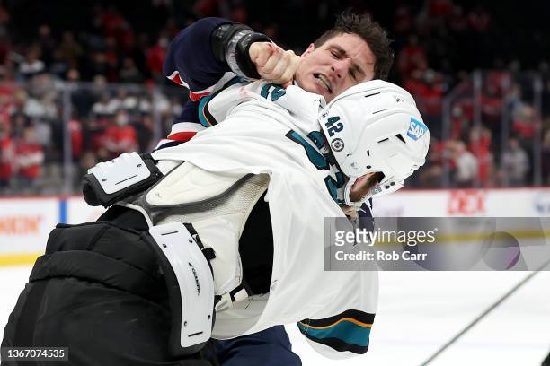 Jonah Gadjovich of the San Jose Sharks and Garnet Hathaway of the Washington Capitals fight following the Sharks 4-1 win at Capital One Arena on...