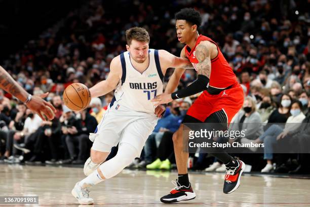 Luka Doncic of the Dallas Mavericks dribbles against Anfernee Simons of the Portland Trail Blazers during the third quarter at Moda Center on January...