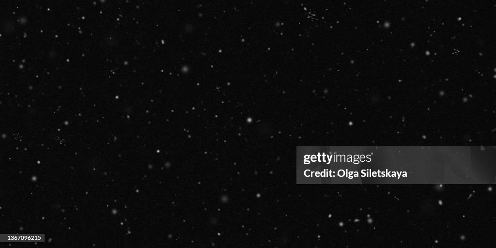 Noise, scratches and dust particles on a black background