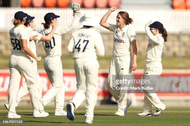 Nat Sciver of England celebrates with her team after taking the wicket of Tahlia McGrath of Australia during day one of the Women's Test match in the...