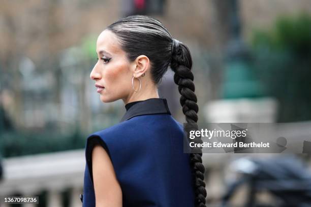 Alexandra Guerain wears a black high neck / sleeveless pullover, a navy blue long buttoned sleeveless blazer jacket dress, outside Jean-Paul...