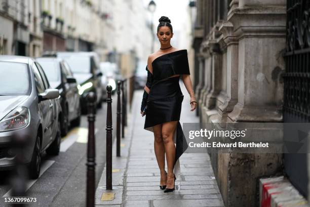Lena Mahfouf aka Lena Situations wears a beige tulle long sleeves t-shirt with black rhinestones wrists and necklace, a black cut-out / embracing...