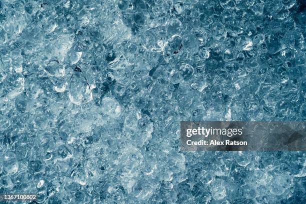 textured shattered fragments of blue ice - broken ice stock pictures, royalty-free photos & images