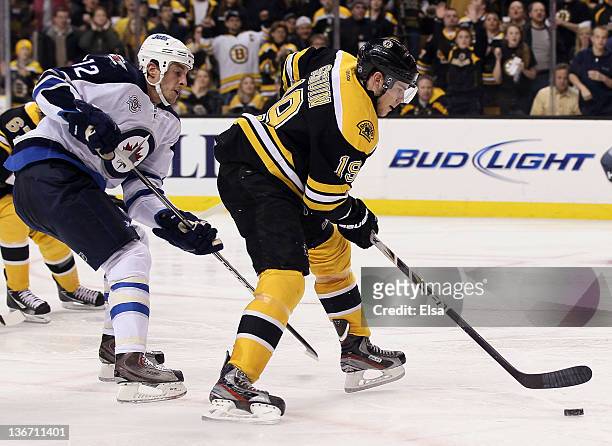 Tyler Seguin of the Boston Bruins heads for the net to score the game winner as Randy Jones of the Winnipeg Jets defends on January 10, 2012 at TD...