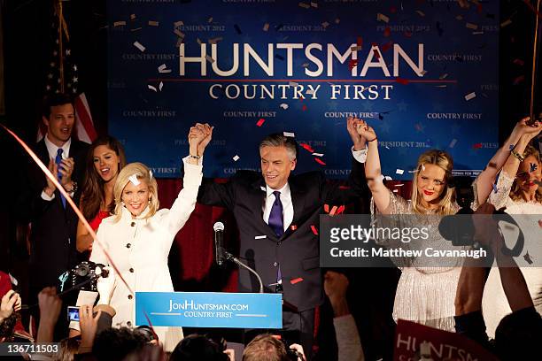 Republican presidential candidate and former Utah Gov. Jon Huntsman celebrates on stage with his son in law Jeff Livingston, daughter Abby...