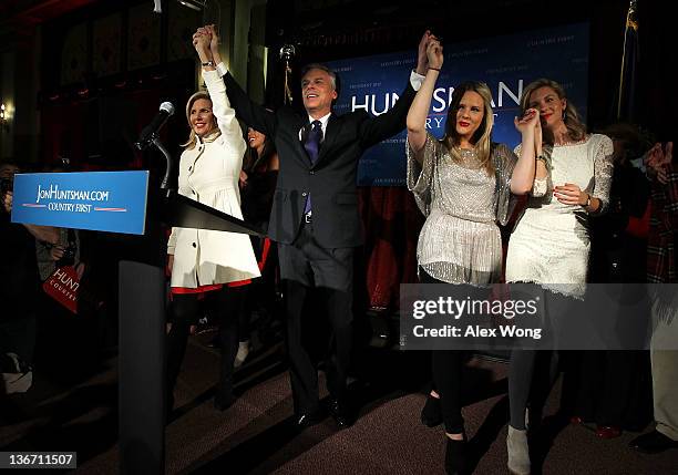 Republican presidential candidate, former Utah Gov. Jon Huntsman hold hands with his wife Mary Kaye , daughters Liddy , and Mary Anne as they...