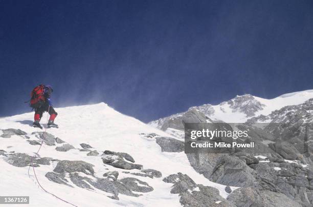 Climber stands on Windy Ridge, near the summit of Mt. McKinley in Denali National Park in Alaska.