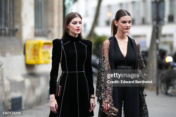 Guest wears diamonds pendant earrings, a black velvet with embroidered white rhinestones stripes pattern high neck / shoulder-pads / long sleeves...