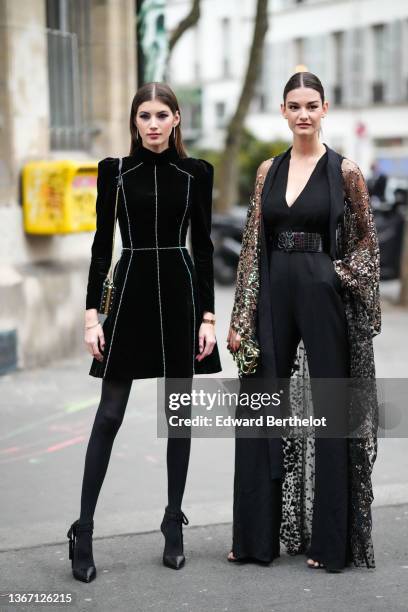 Guest wears diamonds pendant earrings, a black velvet with embroidered white rhinestones stripes pattern high neck / shoulder-pads / long sleeves...