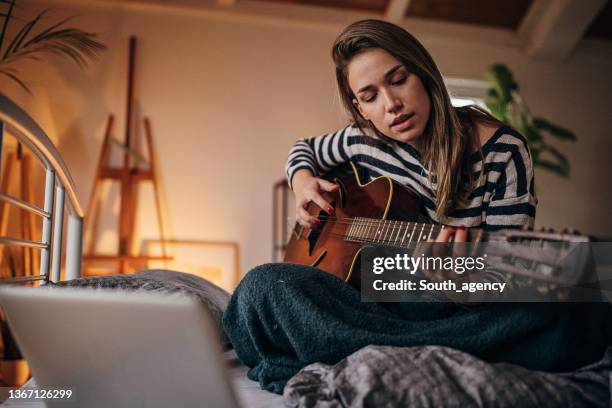 músico femenino componiendo una canción - guitar fotografías e imágenes de stock