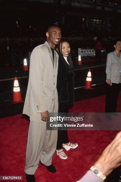 American basketball player Kobe Bryant and American singer, songwriter, and actress Brandy attend the Hollywood premiere of 'Eraser,' held at Mann's...