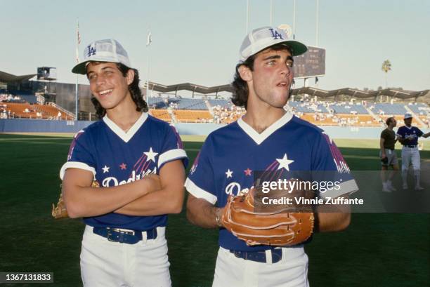 American actor Rob Stone and American actor Brian Bloom, wearing LA Dodgers kits, attend Hollywood All-Stars Baseball Game, staged at Dodger Stadium...