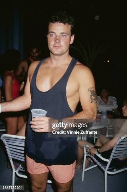 American assault victim John Wayne Bobbitt, wearing a black singlet and peach-coloured shorts, attends an event, circa 1995. In 1993, Bobbitt's wife...