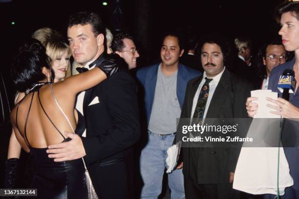 American pornographic actress Jasmine Aloha embraces American assault victim John Wayne Bobbitt, alongside American pornographic actor Ron Jeremy and...