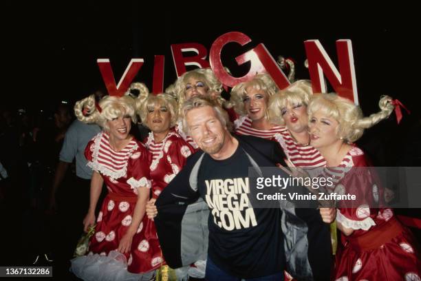 British businessman Richard Branson poses with drag queens at the launch party for virginmega.com, held at the El Capitan Theatre on Hollywood...
