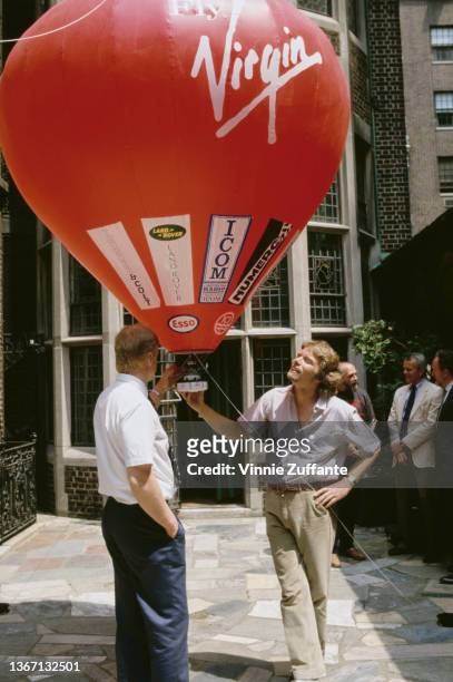 Swedish aeronautical engineer and pilot Per Lindstrand and British businessman Richard Branson attend a press conference to announce their Trans...